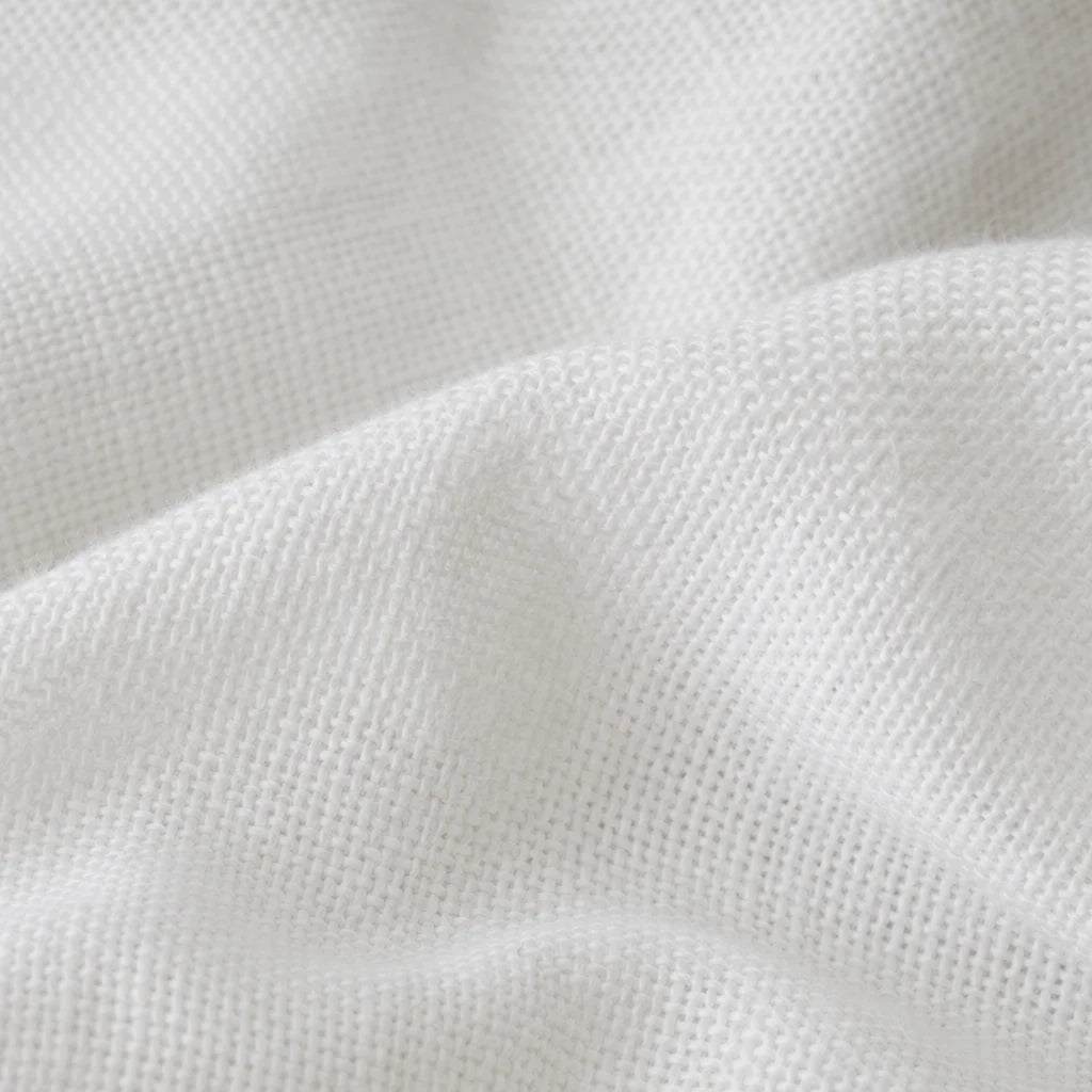 High-resolution macro photography, texture detail. A close-up of the premium cotton weave of a white
