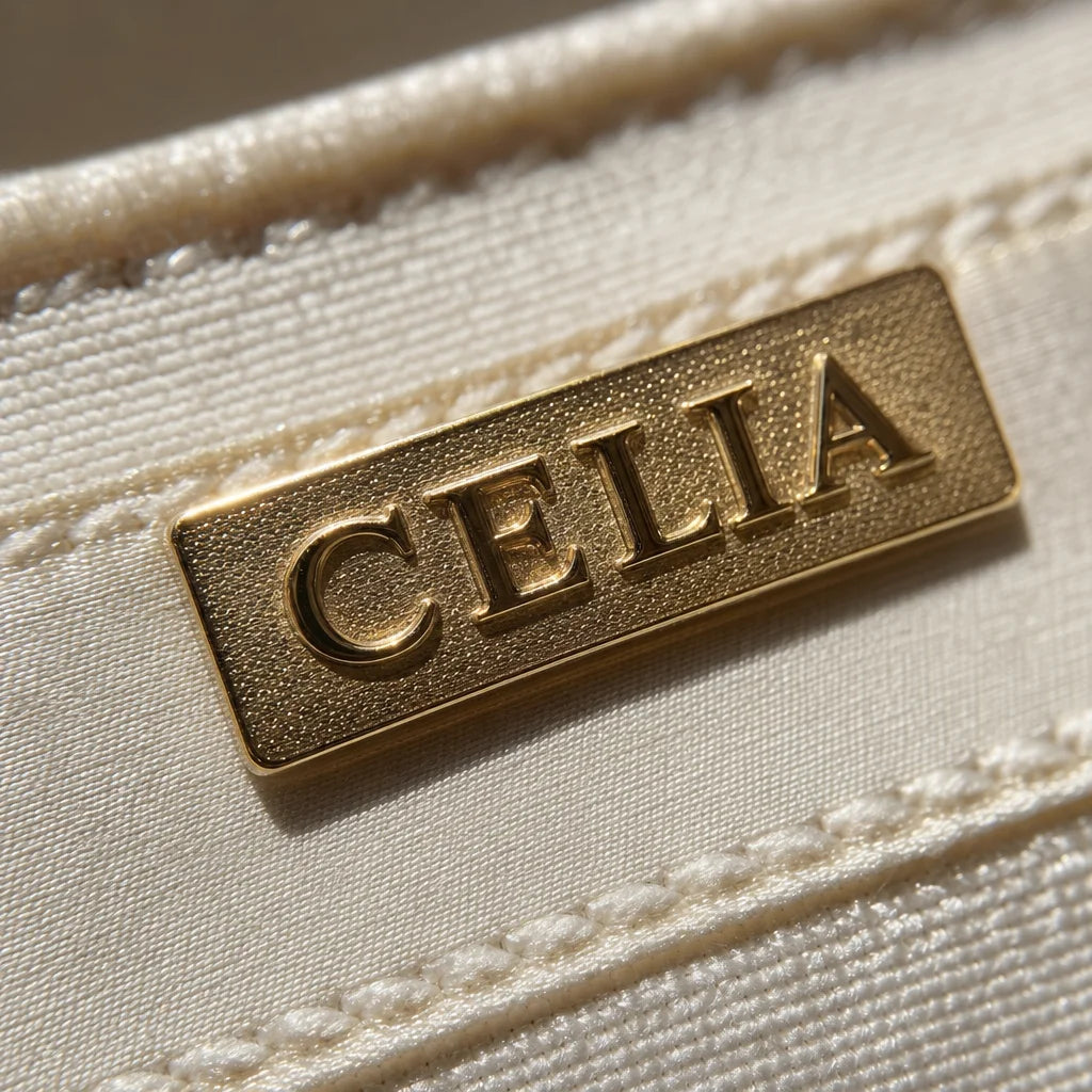 High-resolution macro photography, detail shot. A sharp close-up of the brand's gold metal logo on t